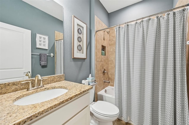 bathroom with shower / bathtub combination with curtain, toilet, vanity, and a textured wall