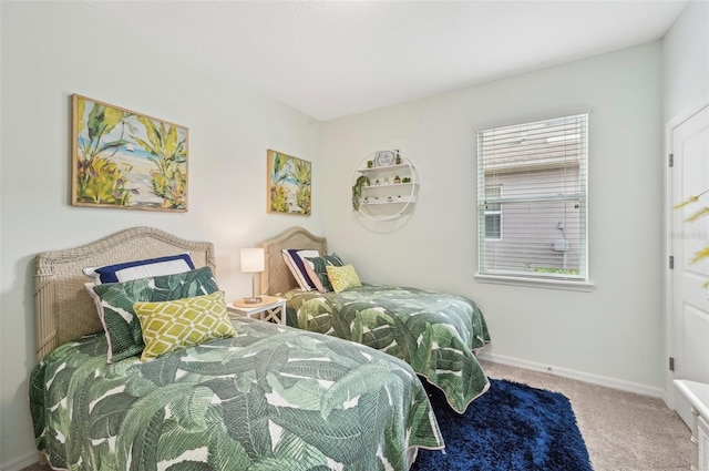 bedroom featuring baseboards and carpet floors