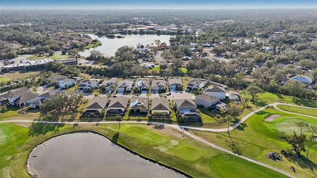 aerial view featuring a residential view, golf course view, and a water view