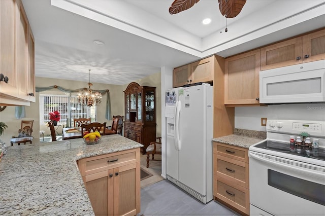 kitchen with pendant lighting, white appliances, light stone countertops, ceiling fan with notable chandelier, and light brown cabinets