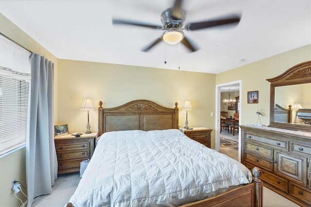 bedroom with ceiling fan with notable chandelier