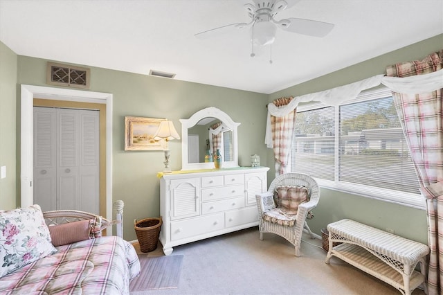 living area featuring carpet floors and ceiling fan