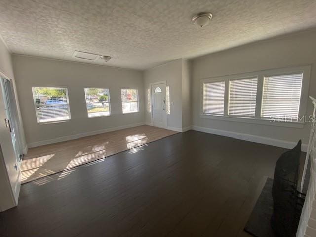 interior space with wood-type flooring and a textured ceiling