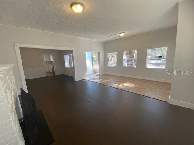 unfurnished room featuring dark hardwood / wood-style flooring and a textured ceiling