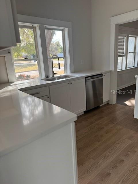 kitchen featuring white cabinetry, plenty of natural light, dishwasher, and sink