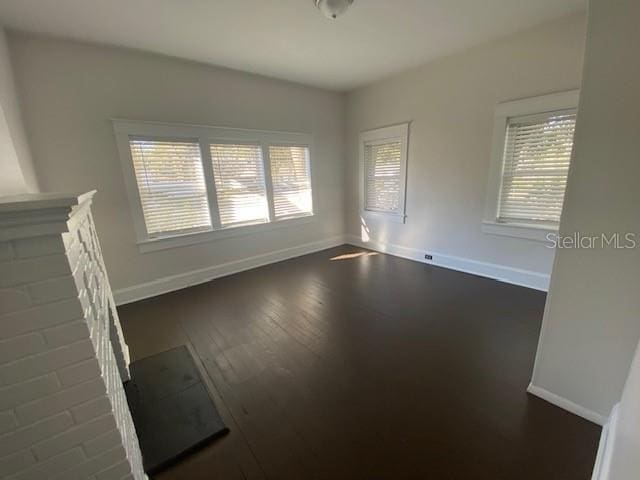 unfurnished living room featuring dark wood-type flooring