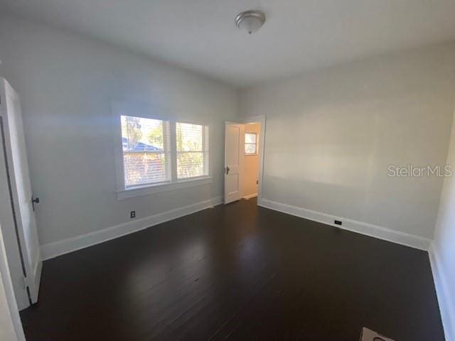 empty room featuring dark wood-type flooring