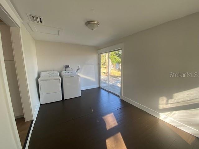 laundry area featuring dark hardwood / wood-style flooring and washer and clothes dryer