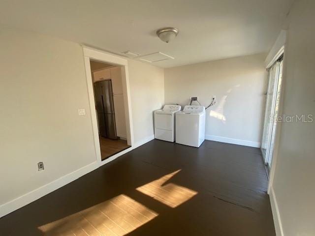 laundry room with dark wood-type flooring and washing machine and clothes dryer