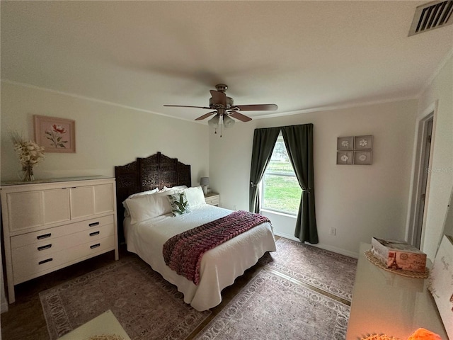 bedroom with ceiling fan and ornamental molding