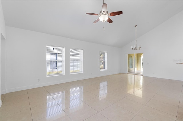 spare room featuring high vaulted ceiling, ceiling fan with notable chandelier, and light tile patterned floors