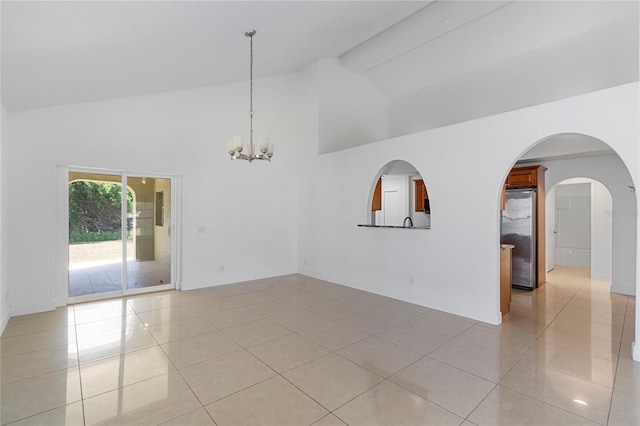 empty room with light tile patterned floors, beam ceiling, high vaulted ceiling, and a chandelier