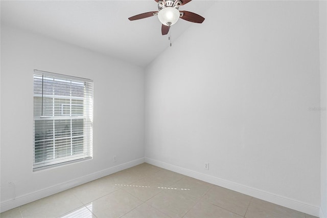 tiled empty room featuring vaulted ceiling and ceiling fan