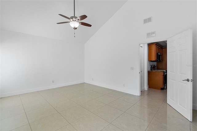 unfurnished room with ceiling fan, high vaulted ceiling, and light tile patterned floors