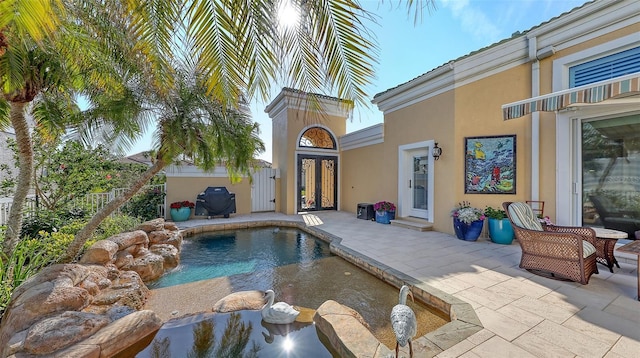 view of swimming pool with grilling area and a patio area