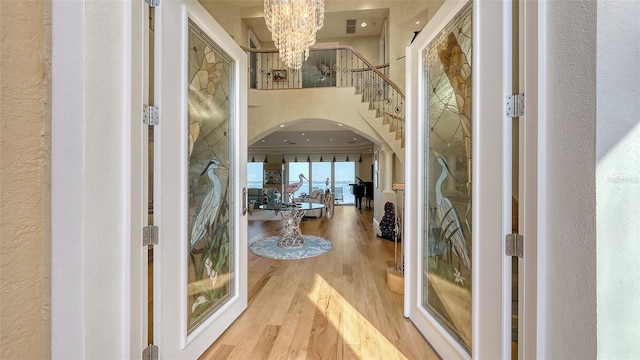 entryway featuring an inviting chandelier and hardwood / wood-style floors