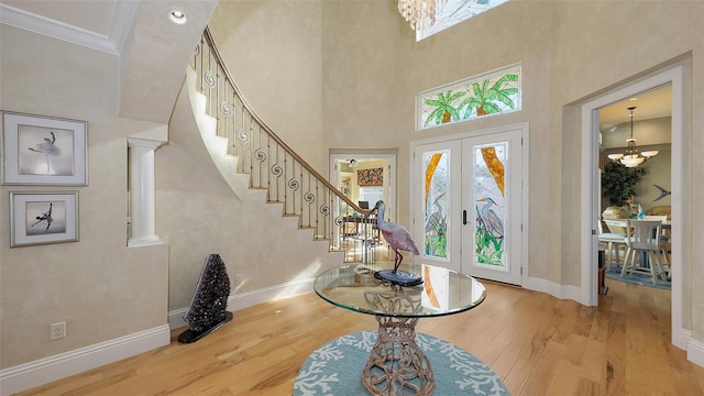 foyer entrance featuring french doors, plenty of natural light, and light hardwood / wood-style flooring