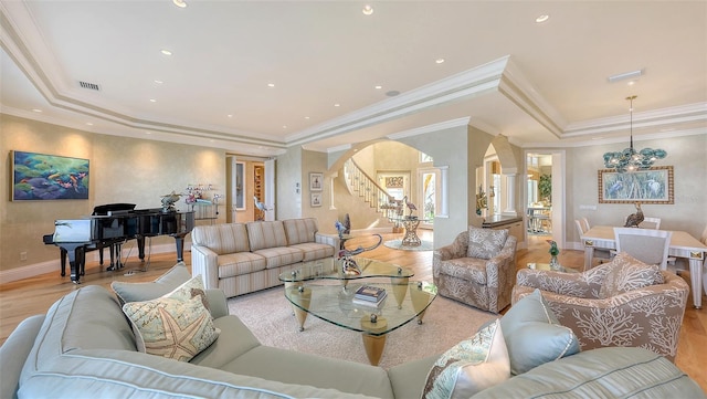 living room featuring light hardwood / wood-style flooring and a tray ceiling