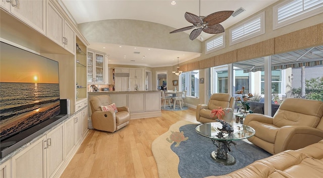 living room with vaulted ceiling, ceiling fan, and light hardwood / wood-style floors