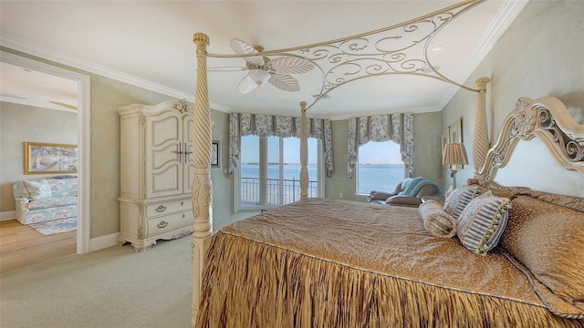 bedroom with ornamental molding, light colored carpet, access to exterior, ceiling fan, and a water view