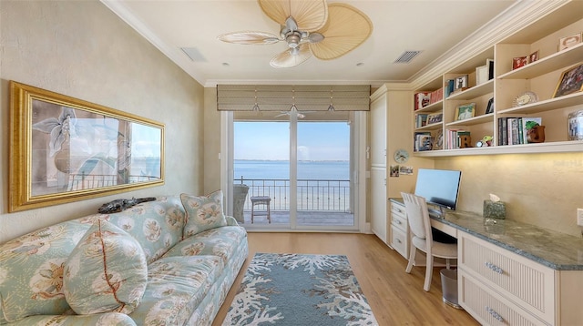 office area with light hardwood / wood-style flooring, built in desk, ornamental molding, and ceiling fan