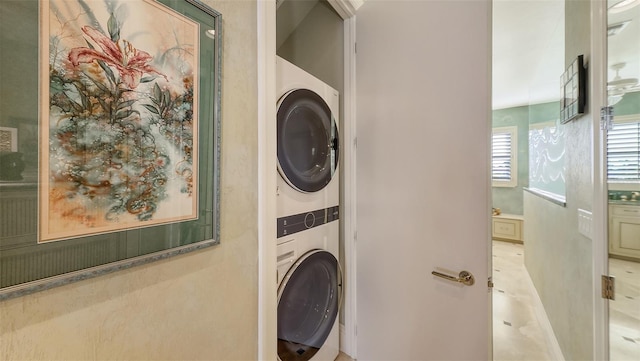 clothes washing area with stacked washer and dryer