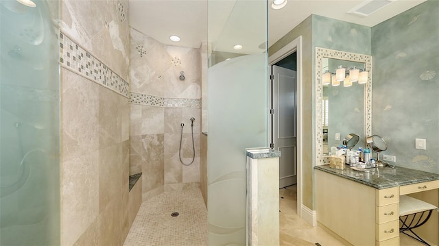 bathroom featuring tile patterned flooring and a tile shower