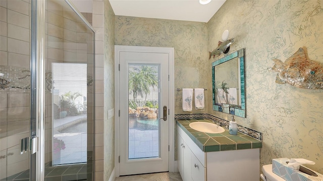 bathroom with vanity, toilet, and walk in shower