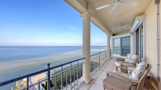 balcony featuring a water view, ceiling fan, and a view of the beach