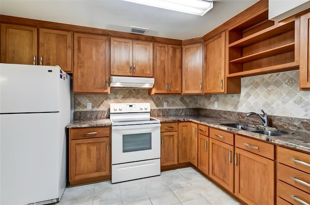 kitchen featuring light tile patterned flooring, tasteful backsplash, sink, dark stone counters, and white appliances