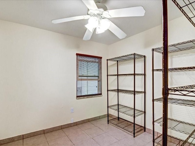 interior space with ceiling fan and light tile patterned flooring