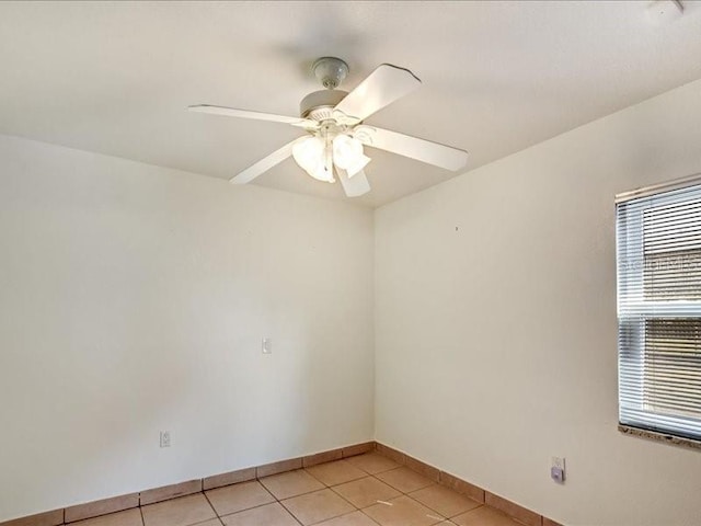 empty room featuring ceiling fan and light tile patterned floors