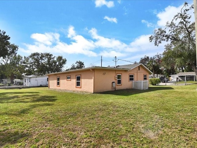 rear view of house with a lawn