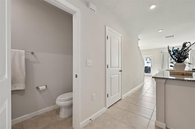 bathroom featuring tile patterned flooring and toilet