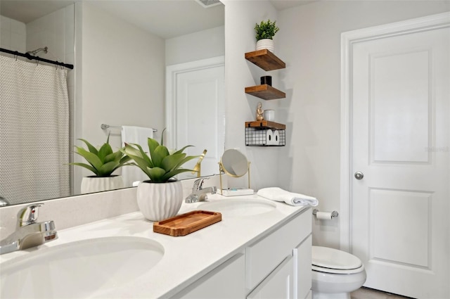 bathroom featuring vanity, walk in shower, and toilet