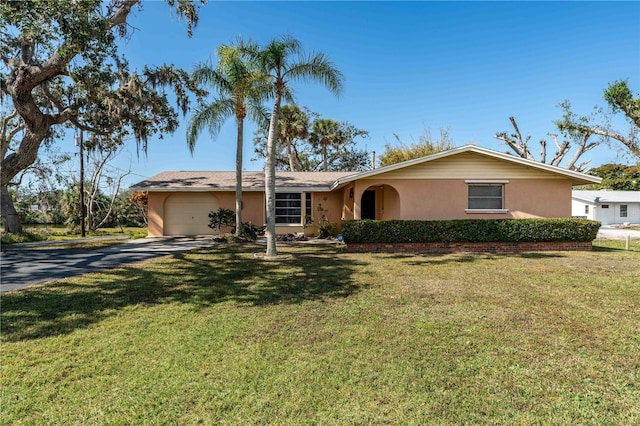 ranch-style home with a garage and a front lawn