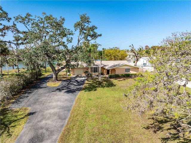 ranch-style home featuring a garage and a front yard