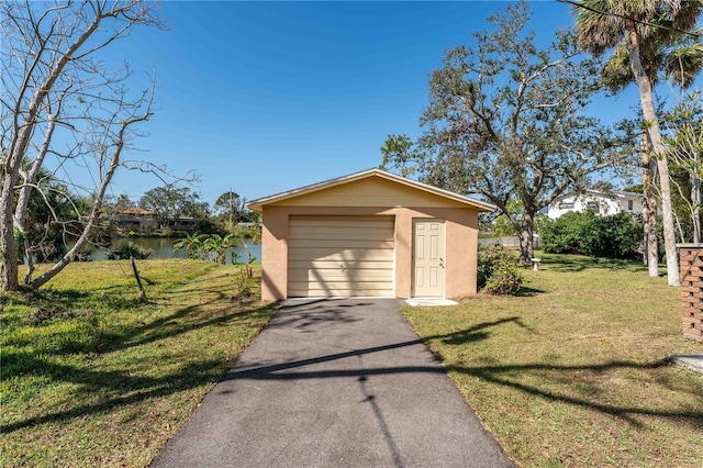 garage with a water view and a yard