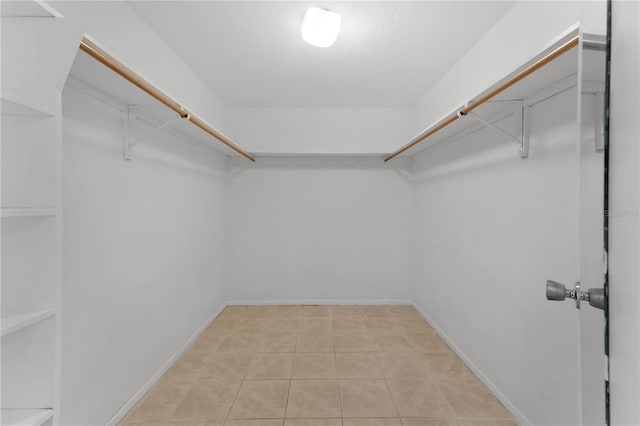 spacious closet featuring light tile patterned floors