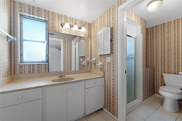 bathroom featuring vanity, a shower with shower door, tile patterned floors, and toilet