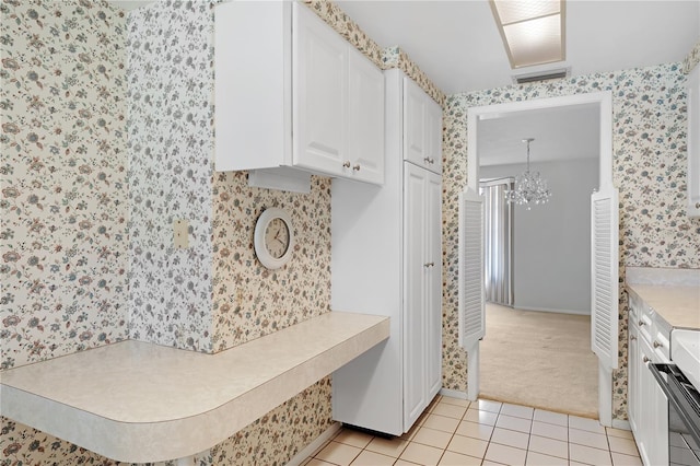 mudroom with light tile patterned floors and a notable chandelier