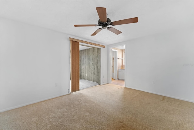 empty room with light colored carpet and ceiling fan