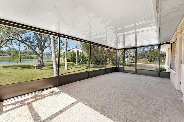 unfurnished sunroom featuring a water view