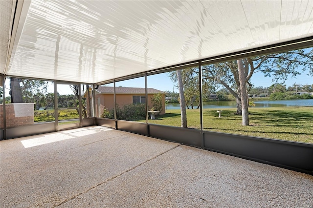 unfurnished sunroom with a water view