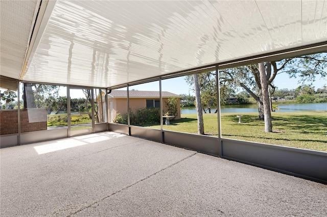 unfurnished sunroom with a water view