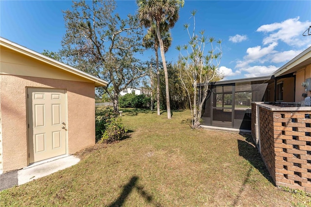 view of yard featuring a sunroom