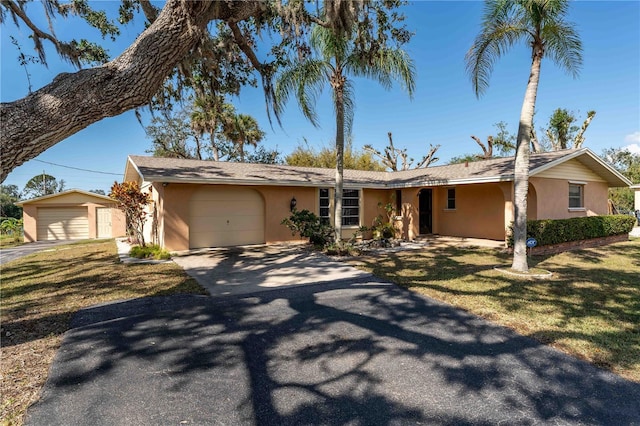 ranch-style house with a garage and a front yard