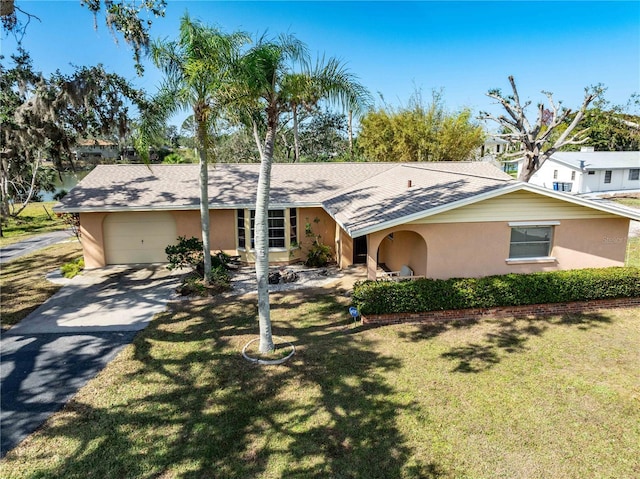 single story home with a garage and a front yard