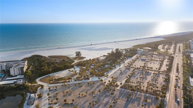 birds eye view of property with a water view and a beach view