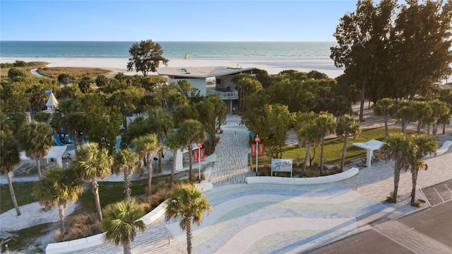 bird's eye view featuring a water view and a beach view